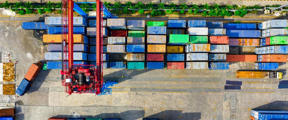 Colorful cargo containers organized at a shipping yard in North Jakarta, Indonesia.